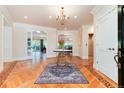 Elegant foyer featuring hardwood floors, stylish area rug, chandelier, and access to multiple rooms at 4800 S Franklin St, Cherry Hills Village, CO 80113