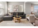 Comfortable living room with a sectional sofa, neutral colors, and stylish decor at 8855 E 55Th Ave, Denver, CO 80238