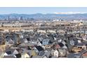 Expansive view of a residential neighborhood and skyline backed by distant, snow-capped mountains at 8855 E 55Th Ave, Denver, CO 80238