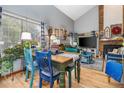 Open-concept dining and living area with hardwood floors, high ceilings, and cozy decor at 2685 S Dayton Way # 253, Denver, CO 80231