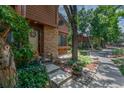 Cozy townhouse exterior with landscaped garden, stone details, and a welcoming entrance at 2685 S Dayton Way # 253, Denver, CO 80231