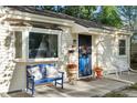 Welcoming front porch with a blue bench, colorful flower pots, and comfortable seating for relaxing outdoors at 60 Vrain St, Denver, CO 80219
