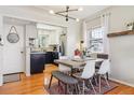 Bright dining area with modern lighting, wood floors, and access to the kitchen at 1624 S Elizabeth St, Denver, CO 80210