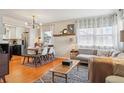 Cozy living room with an open floor plan, dining area, and updated kitchen at 1624 S Elizabeth St, Denver, CO 80210