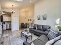 Living room showcasing wood floors, staircase, and view into the dining area at 6332 Zang Court # A, Arvada, CO 80004