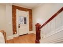 Welcoming entryway with original hardwood floors, exposed brick, and a staircase with white railing at 404 S Grant St, Denver, CO 80209