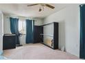 Cozy bedroom with bright window, ceiling fan, and versatile Murphy bed, offering both space and functionality at 219 Douglas Fir Ave, Castle Rock, CO 80104