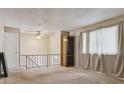 This spacious bonus room offers versatile living with a ceiling fan and natural light from large windows at 219 Douglas Fir Ave, Castle Rock, CO 80104