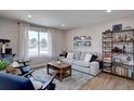 Bright living room featuring neutral walls, light hardwood floors, and stylish furniture at 5945 W 86Th Ave, Arvada, CO 80003