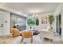 Stylish living room featuring modern decor, large window, and light hardwood floors at 1304 Snowberry # 203, Louisville, CO 80027