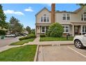 Attractive townhome featuring manicured landscaping, a paved walkway, and convenient parking at 14396 E Temple Pl # D, Aurora, CO 80015