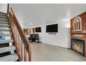 Open-concept living room with modern flooring and a staircase leading to the upper level at 14396 E Temple Pl # D, Aurora, CO 80015