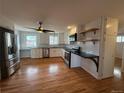 Bright kitchen with stainless steel appliances, white cabinets, and hardwood floors at 4670 Independence St, Wheat Ridge, CO 80033