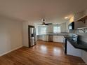 Bright kitchen with stainless steel appliances, white cabinets, and hardwood floors at 4670 Independence St, Wheat Ridge, CO 80033