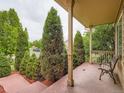 Inviting front porch with brick flooring and a charming bench at 5553 Jasper St, Denver, CO 80239