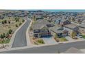 Aerial view of a two-story home, spacious driveway, and well-kept lawn in a neighborhood at 2177 Shadow Creek Dr, Castle Rock, CO 80104