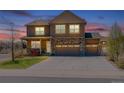 Beautiful two-story home featuring a stone facade and three-car garage on a quiet street at 2177 Shadow Creek Dr, Castle Rock, CO 80104