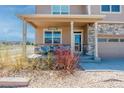 Charming front porch area with cozy seating, decorative stone accents, and a welcoming entrance at 2177 Shadow Creek Dr, Castle Rock, CO 80104