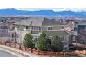 A gorgeous home with professional landscaping featuring lush greenery, a wood fence, and mountain views at 3925 W 149Th Ave, Broomfield, CO 80023