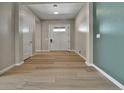 Bright entryway features light wood flooring and modern paint accents at 11464 Stonewash St, Littleton, CO 80125
