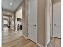 Inviting hallway with wood flooring, neutral paint, and modern white trim at 11464 Stonewash St, Littleton, CO 80125