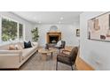 Inviting living room with fireplace, neutral palette, and great natural light at 9123 W Arbor Ave, Littleton, CO 80123
