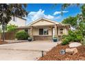 Charming bungalow-style home with manicured landscaping, inviting curb appeal, and a welcoming front porch at 404 S Jasmine St, Denver, CO 80224