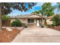 Charming bungalow-style home with manicured landscaping, inviting curb appeal, and a welcoming front porch at 404 S Jasmine St, Denver, CO 80224