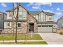 Charming two-story home with stone accents, a well-maintained lawn, and an attached two-car garage at 7173 S Shady Grove Ct, Aurora, CO 80016