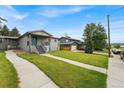 Charming home with well-manicured lawn and walkway leading to the front door, next to another house at 1655 Yates St, Denver, CO 80204