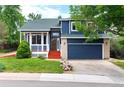 Inviting two-story home with a well-manicured lawn and attached two-car garage at 4257 S Andes Way, Aurora, CO 80013