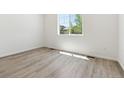 Bright bedroom features sleek flooring and natural light from a large window at 18951 E 96Th Pl, Commerce City, CO 80022