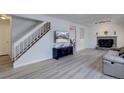 Bright living room featuring hardwood floors, fireplace, and staircase at 17912 E Milan Pl, Aurora, CO 80013