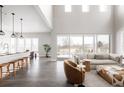Open-concept living space with high ceilings, large windows, and stylish furnishings perfect for modern living and entertaining at 533 Red Thistle Dr, Highlands Ranch, CO 80126