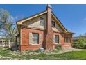 A charming brick house with a distinctive chimney and well-maintained landscaping at 5475 W 1St Ave, Lakewood, CO 80226