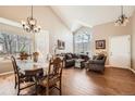 Bright and airy living room with hardwood floors, vaulted ceilings, and lots of natural light at 5758 S Jasper Way, Centennial, CO 80015