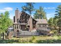 Beautiful home with an expansive deck perfect for entertaining and enjoying the surrounding nature at 160 Bristlecone, Boulder, CO 80304