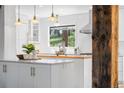 Bright, updated kitchen with white cabinets, butcher block island and stainless steel appliances at 160 Bristlecone, Boulder, CO 80304