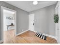Bright bedroom with hardwood floors, neutral walls, and an adjacent room visible through an open doorway at 215 E 11Th Ave # D8, Denver, CO 80203
