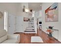 Elegant entryway with hardwood floors and staircase at 2946 S Espana Ct, Aurora, CO 80013