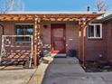 Inviting front entrance with a swing, red door and a pergola over the walkway at 640 Marble St, Broomfield, CO 80020