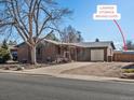 Charming brick home featuring convenient camper storage behind a gate at 640 Marble St, Broomfield, CO 80020