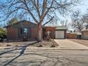 Charming brick home with covered porch, mature tree, and inviting curb appeal at 640 Marble St, Broomfield, CO 80020