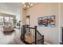 Spacious foyer with hardwood floors, staircase, and views into the living area at 12114 Alcott St, Westminster, CO 80234