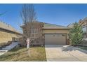 Inviting single-story home with a well-maintained lawn and attached two-car garage at 12114 Alcott St, Westminster, CO 80234