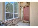 Welcoming front porch with brick detail, large window, and decorative front door at 12114 Alcott St, Westminster, CO 80234