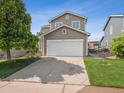 Beautiful 2-story home with a well-maintained front yard and a spacious driveway, offering comfort at 9697 Marmot Ridge Cir, Littleton, CO 80125