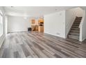 Inviting living space featuring hardwood floors and a staircase, blending style and functionality at 9697 Marmot Ridge Cir, Littleton, CO 80125