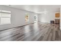 Bright living area with new floors, freshly painted walls, and natural light creates a welcoming space at 9697 Marmot Ridge Cir, Littleton, CO 80125