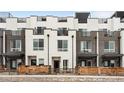 Modern townhome exterior featuring sleek lines, a mix of brick and siding, and private balconies at 3520 W Connejos Pl # 5, Denver, CO 80204